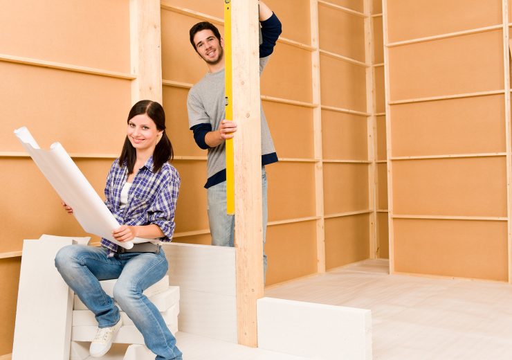 Home improvement young couple with blueprints